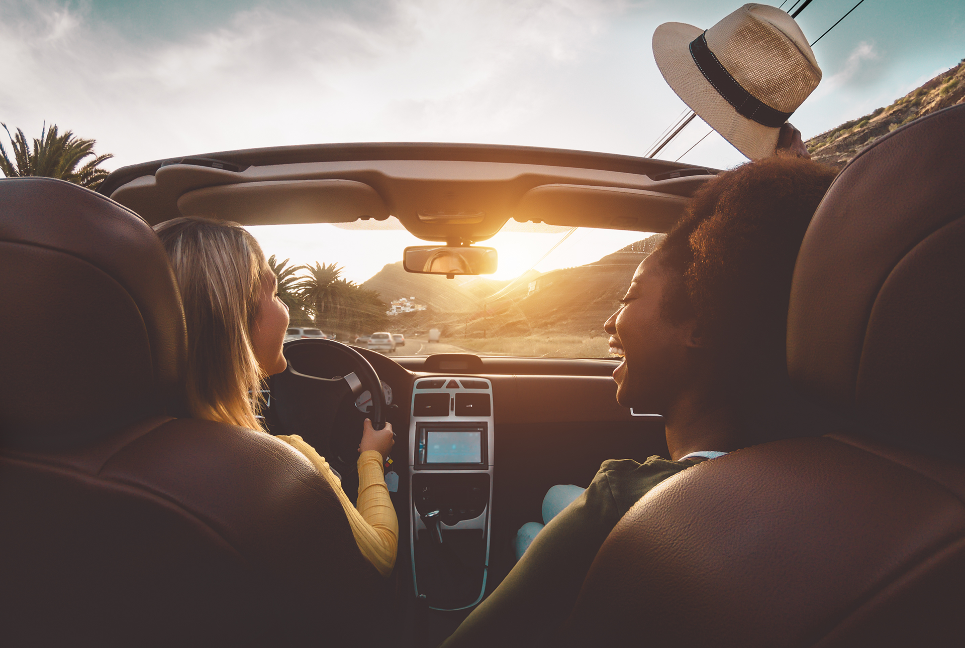 two people in a convertible car